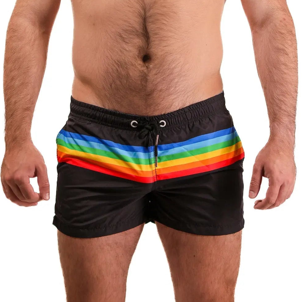 This image features a model wearing the Driftline Pride Shorts, designed for both style and comfort. The shorts are black with a vibrant, multicolored vertical stripe that adds a bold touch to the design.