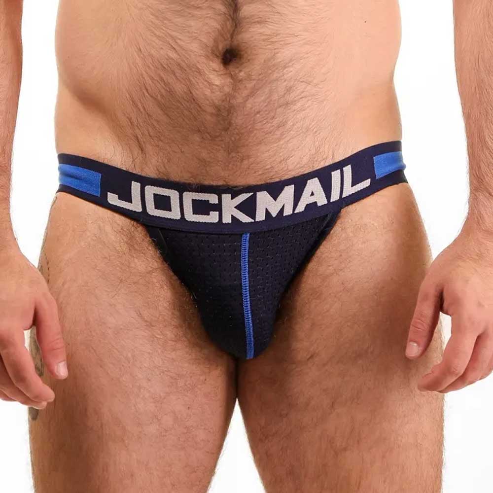 Man wearing a blue jockstrap with 'JOCKMAIL' branding on a white background